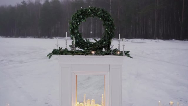 Candles in fireplace ourdoors at winter