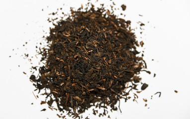 dried loose oriental asian black tea leaves for tea infusion on white background close up