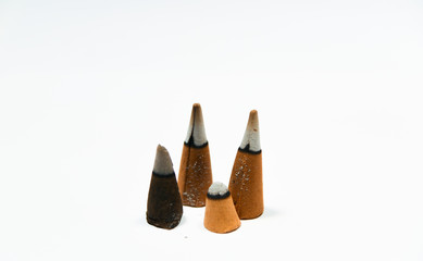 isolated perfumed oriental buddhist  temple incense  cones burning on white background