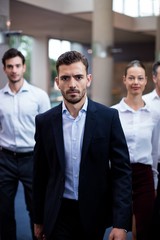 Business executives walking in a conference center lobby