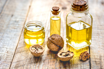 cosmetic and therapeutic walnut oil on wooden background