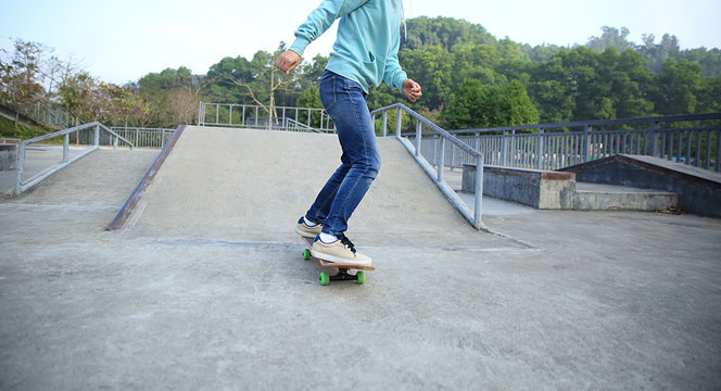 young skateboarder riding skateboard at skatepark
