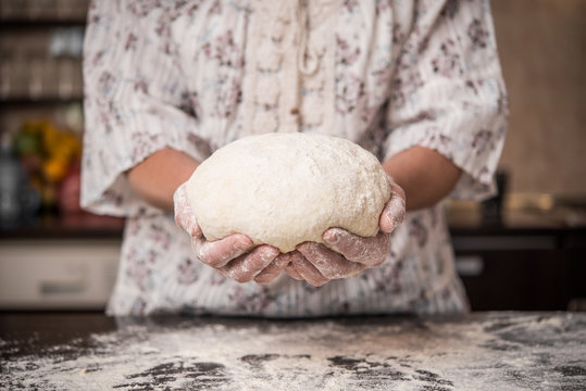 Woomens hands holding a finished clean dough