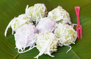 sweet balls on banana leaf