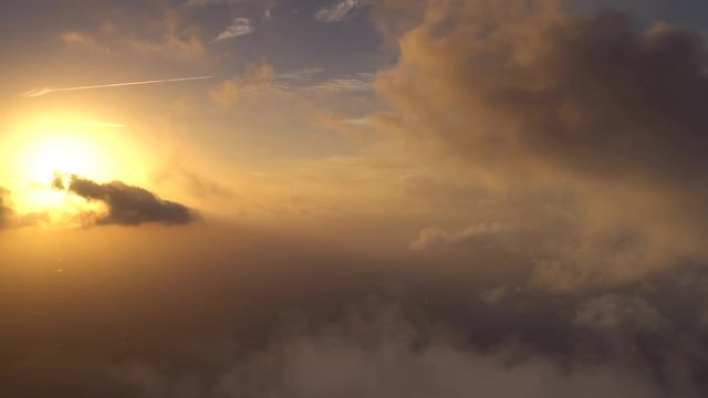 Aerial sunset behind clouds, Rays, Golden light