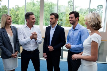 Business executives interacting in a conference center lobby