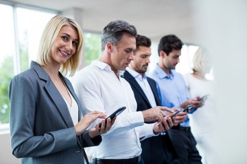 Business executives using digital tablet and mobile phone