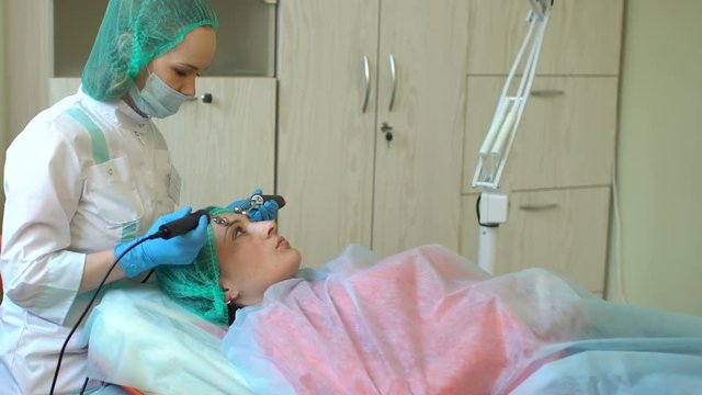 Cosmetology doctor female makes treatment procedure her patient in medical center