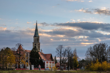 Fototapeta premium Castle and church in the autumn, selective focus