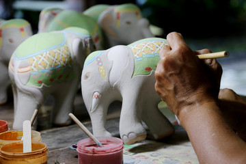 CHIANGMAI, THAILAND - OCTOBER 10, 2016 : Thai people working painted on pottery, ceramic elephant...