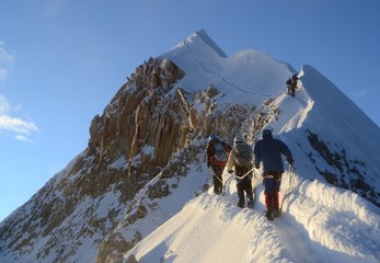 Team of three Mountaineers push the last bit to the spectacular summit of Huayna Potosi.