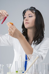 Portrait of Female Laboratory Staff with Flask and Tangerine Testing in Lab