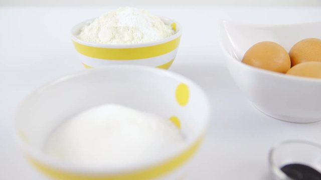 Sliding over butter, eggs, flour and sugar closeup 4K