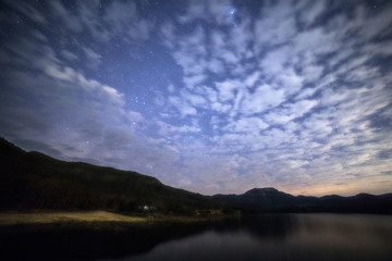 Peaceful starry and clouds night sky background