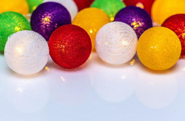 Bright Christmas garland spheres from threads on a white background