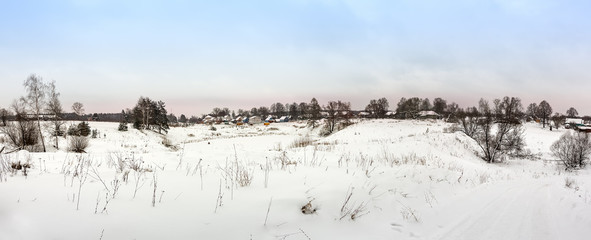 The Russian village in frosty winter day