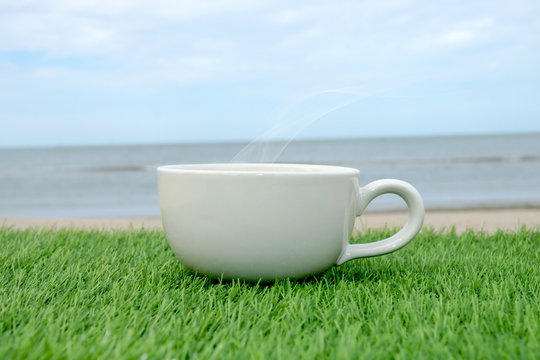 White coffee cup on the beach
