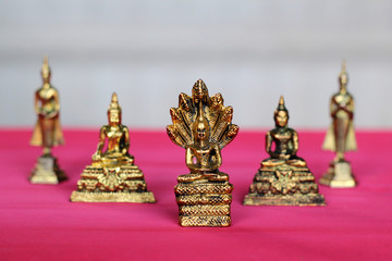 Fototapeta na wymiar Buddha on a wooden pink