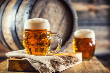 Beer. Two cold beers. Draft beer. Draft ale. Golden beer. Golden ale. Two gold beer with froth on...