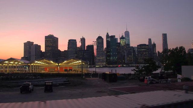CLOSE UP: Pier 2 waterfront sport fields over Manhattan downtown skyline at dawn