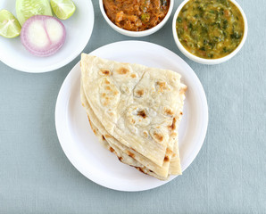 Indian food naan, a type of traditional and popular bread, and vegetable curries.