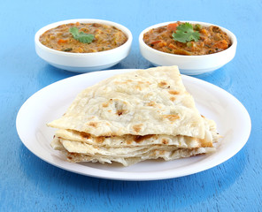 Indian food naan, a type of traditional and popular bread, and vegetable curries.