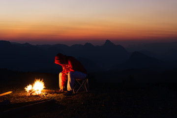 People are putting wood into the fire, because the weather is ve