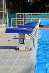 Naklejka premium starting blocks at swimming pool 