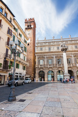 Sunny view of the Piazza delle Erbe, palazzo Maffei and Gardello tower at historical center of Verona, Veneto region, Italy.