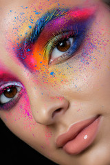 Close up view of female face with bright multicolored fashion ma
