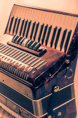 part red musical instrument accordion, white background