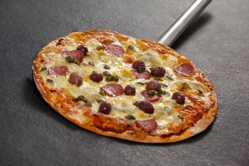 Delicious italian pizza served on pizza peel