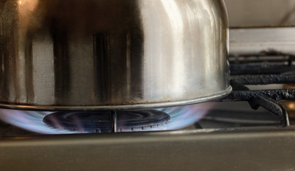 Brilliant metal kitchen ware costs on the lit gas torch.