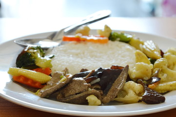 stir fried mixed vegetable with pork liver on rice