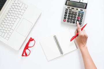 Obraz premium Business woman using calculator and laptop on white desk, Accoun