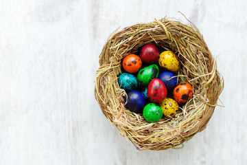 A nest with colored Easter eggs at home on Easter day