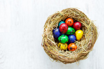 A nest with colored Easter eggs at home on Easter day