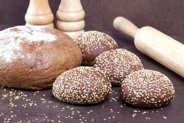 Different fresh bread on rustic backgrounds.
