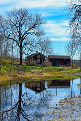 Old wooden house on pond shore