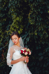 beautiful bride with a bouquet on dark background