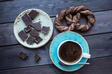 Cup of coffee with chocolate and pretzel. Top view