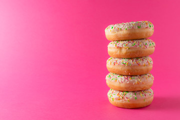Stack of donuts on pink background
