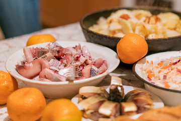 Country dinner with roast potatoes, smoked fish, coleslaw and mandarin