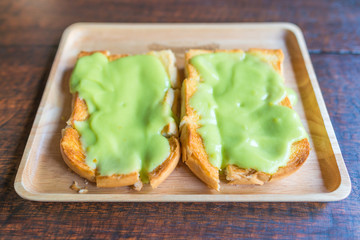 bread custard with topping pandan flavor on wooden table