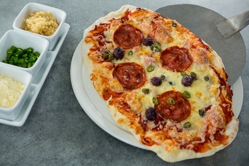Italian pizza being served on a plate