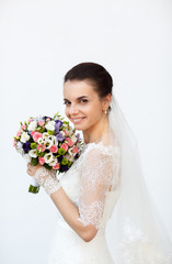 bride  admires her bouquet of colored flowers