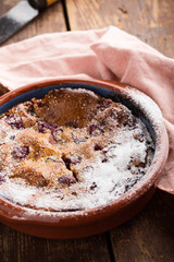 Classic french dessert cherry clafoutis in ceramic bowl