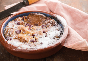 Classic french dessert cherry clafoutis in ceramic bowl