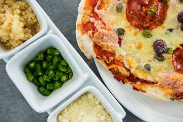 Italian pizza served on a plate with various ingredients