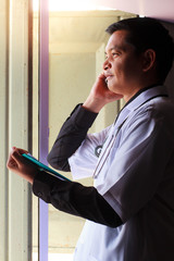 Fototapeta premium Asian doctor used smartphone.
